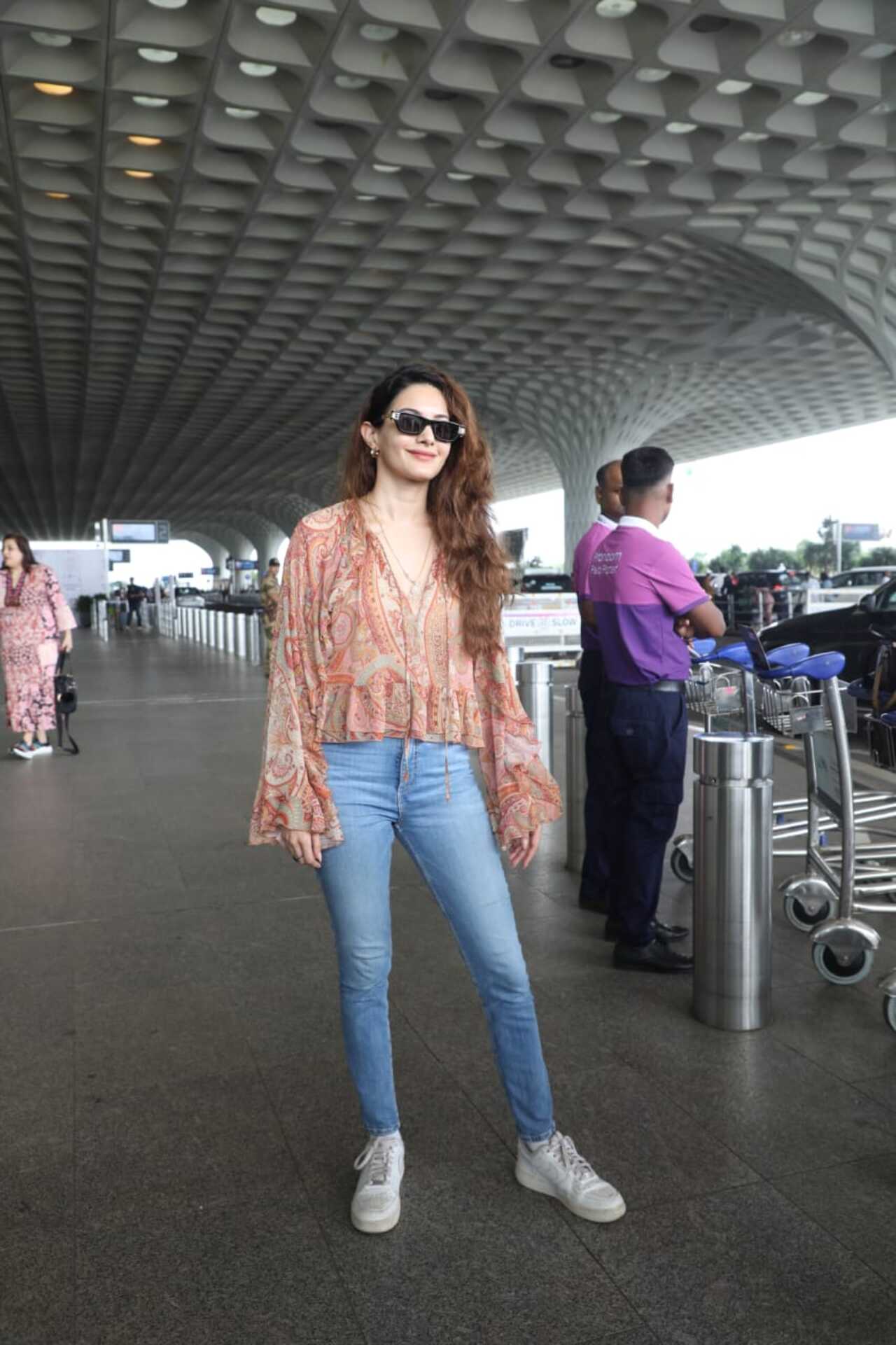 Amyra Dastur kept it breezy in a peach printed bohemian-style top with flowy sleeves, paired with light blue skinny jeans and white sneakers.